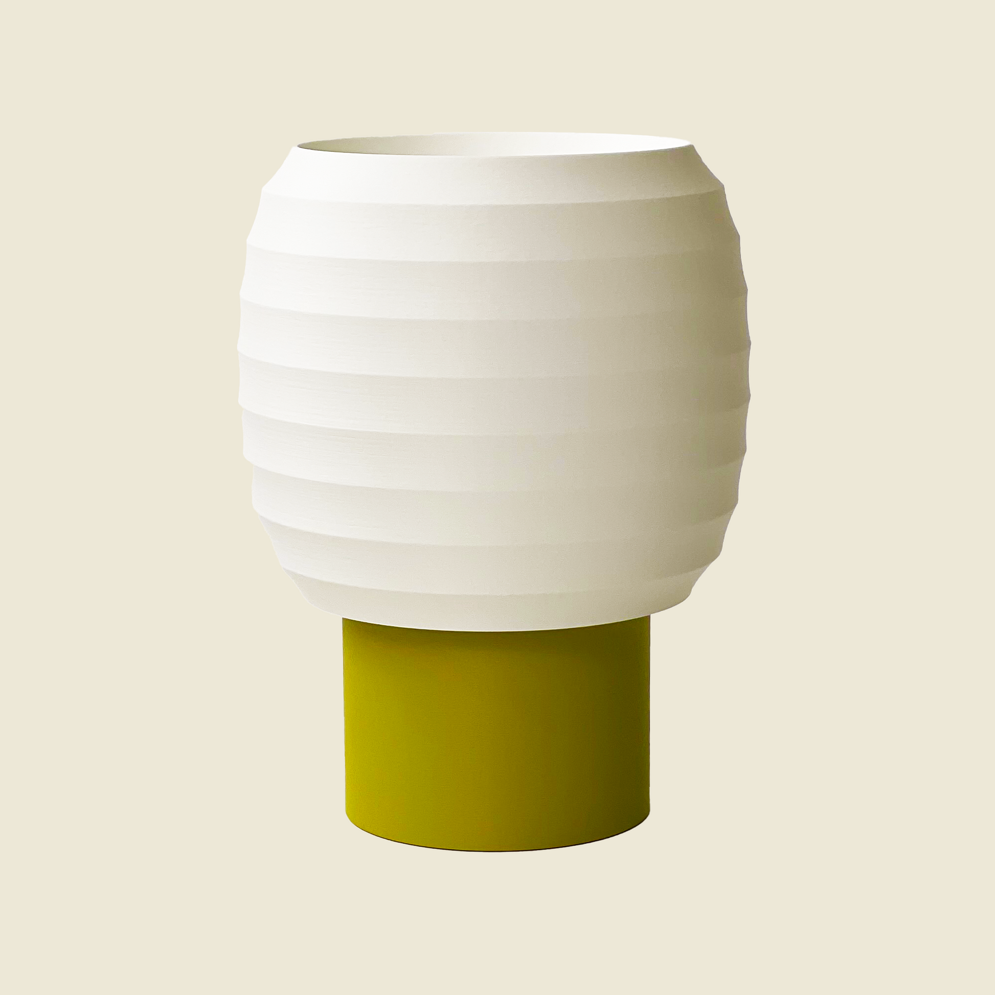 a white and green vase sitting on top of a table