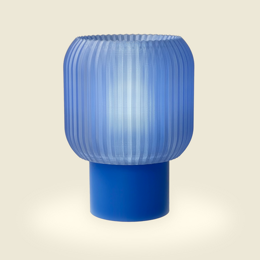 a blue lamp sitting on top of a table