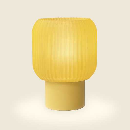 a yellow lamp sitting on top of a table