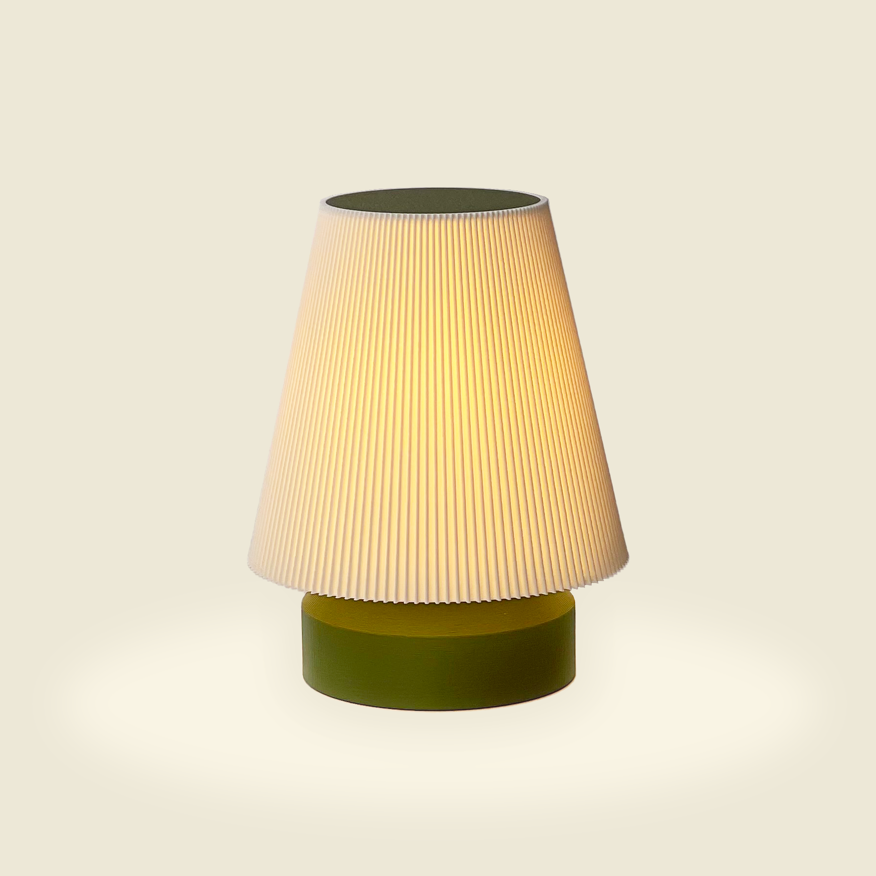 a green lamp with a white shade on it