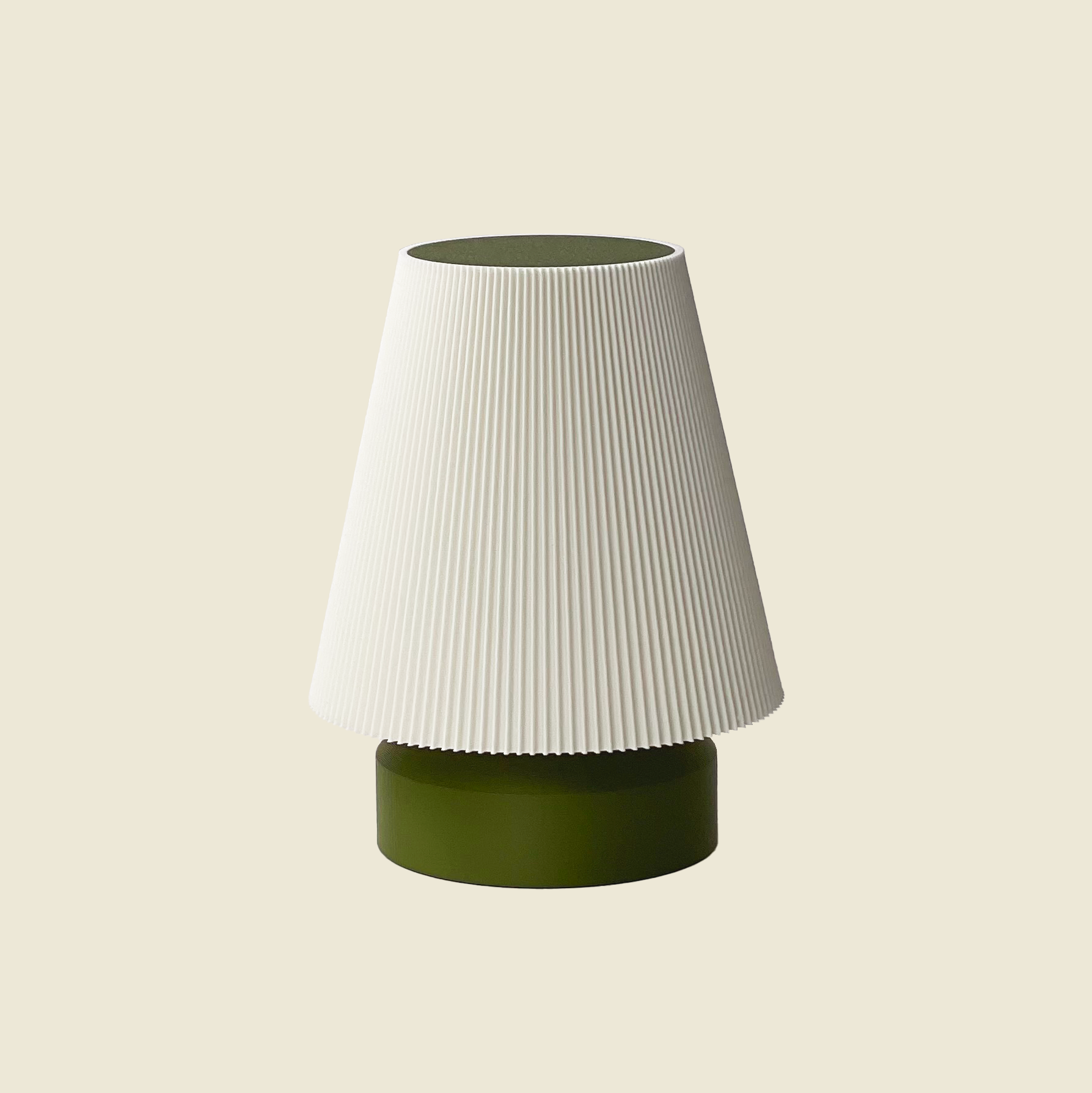 a green and white lamp shade sitting on top of a table