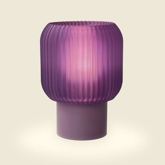 a purple lamp sitting on top of a table