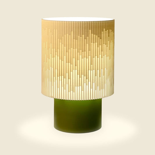 a green and white lamp on a white background