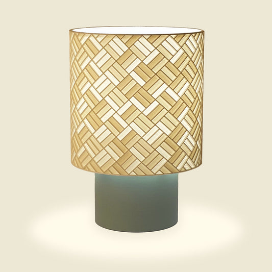 a patterned lamp that is sitting on a table